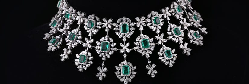 A pretty diamond and green gemstone studded bridal necklace.